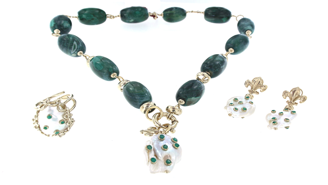 set of golden, greend and white necklace, ring and earrings with precious stones
