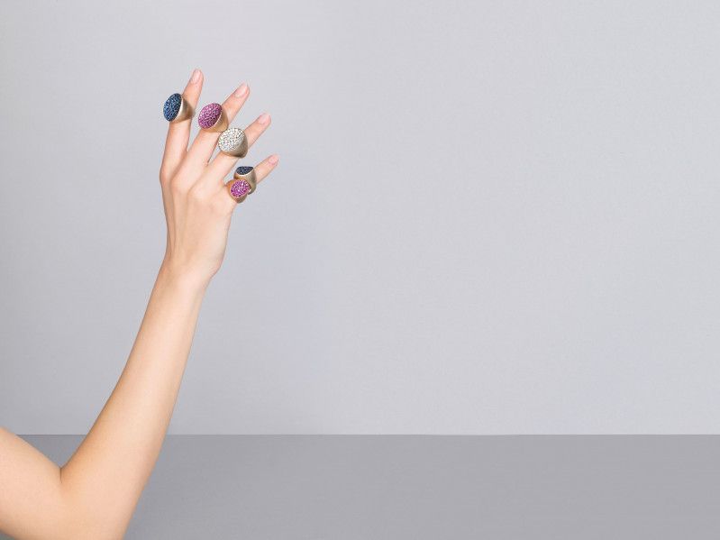 hand showing 4 golden and colored rings