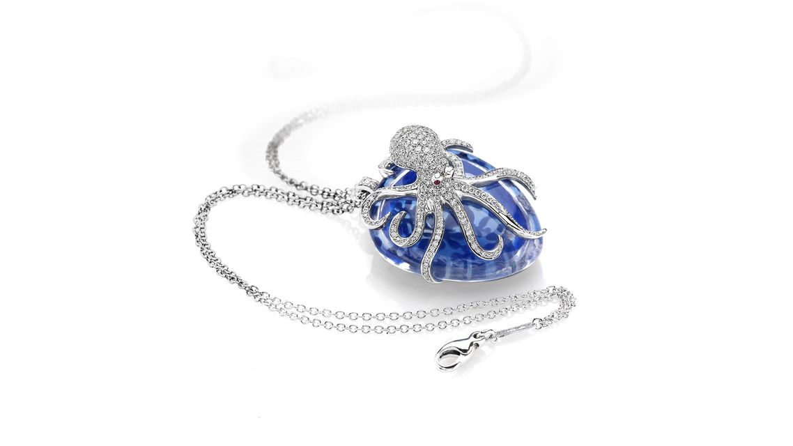 silver necklace with octopus-shaped pendant on a big blue stone