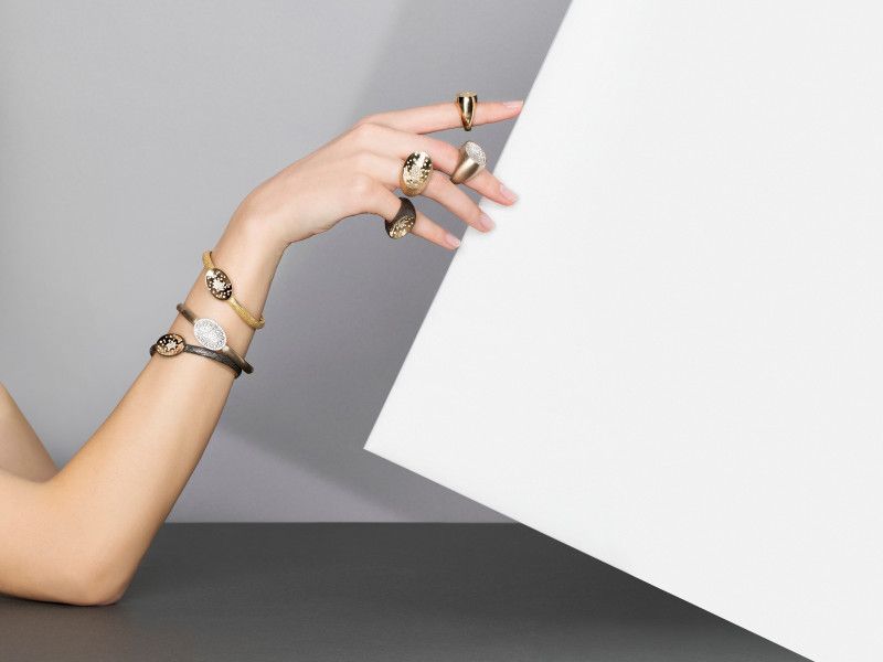 hand showing golden rings and golden bracelets