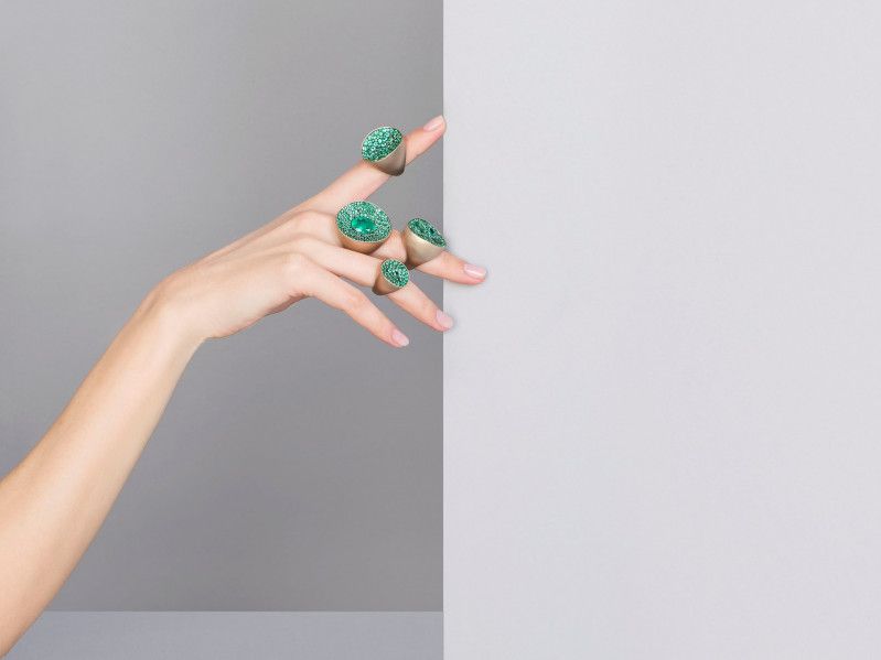 hand with four big and green rings