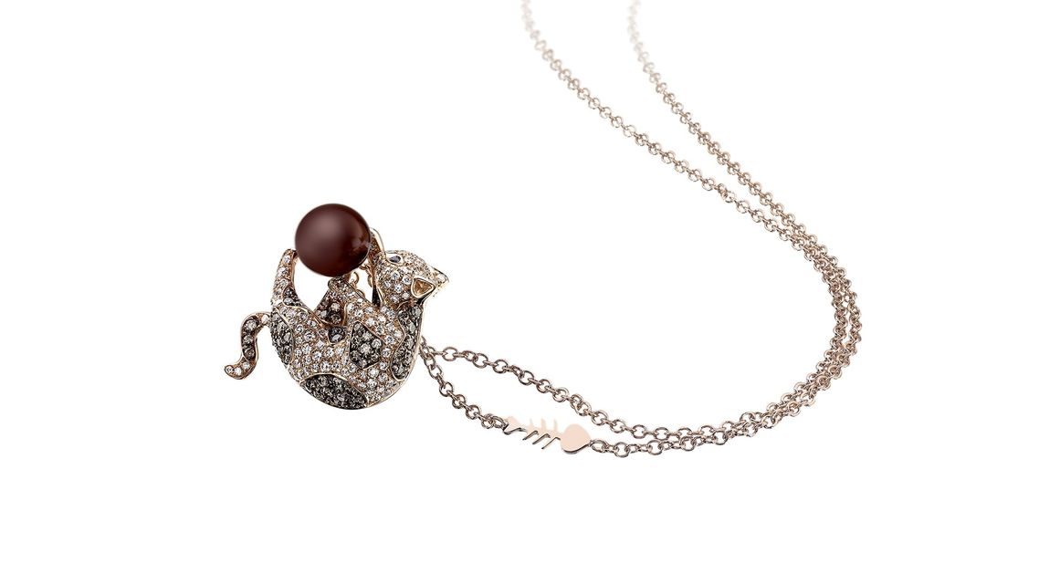 golden necklace with cat-shaped pendant and precious stones