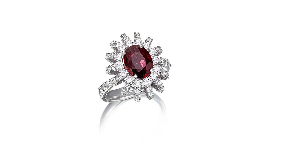 silver ring with precious stones and red stone