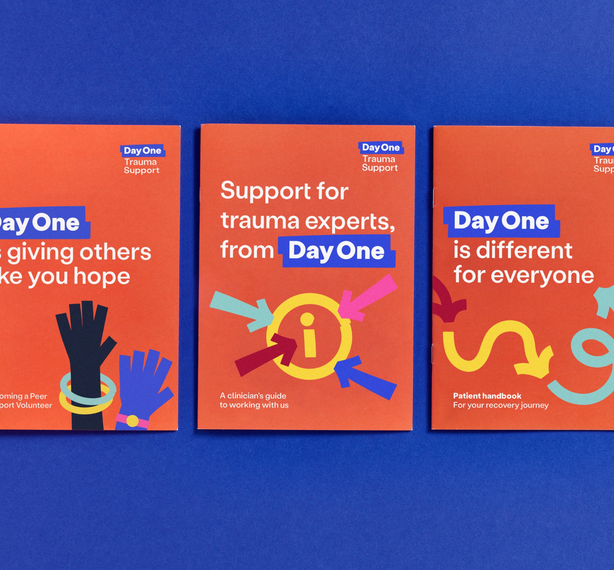 Three booklets for day one are seen on a dark blue background, with the two on either ends of the middle one being cut off by the framing