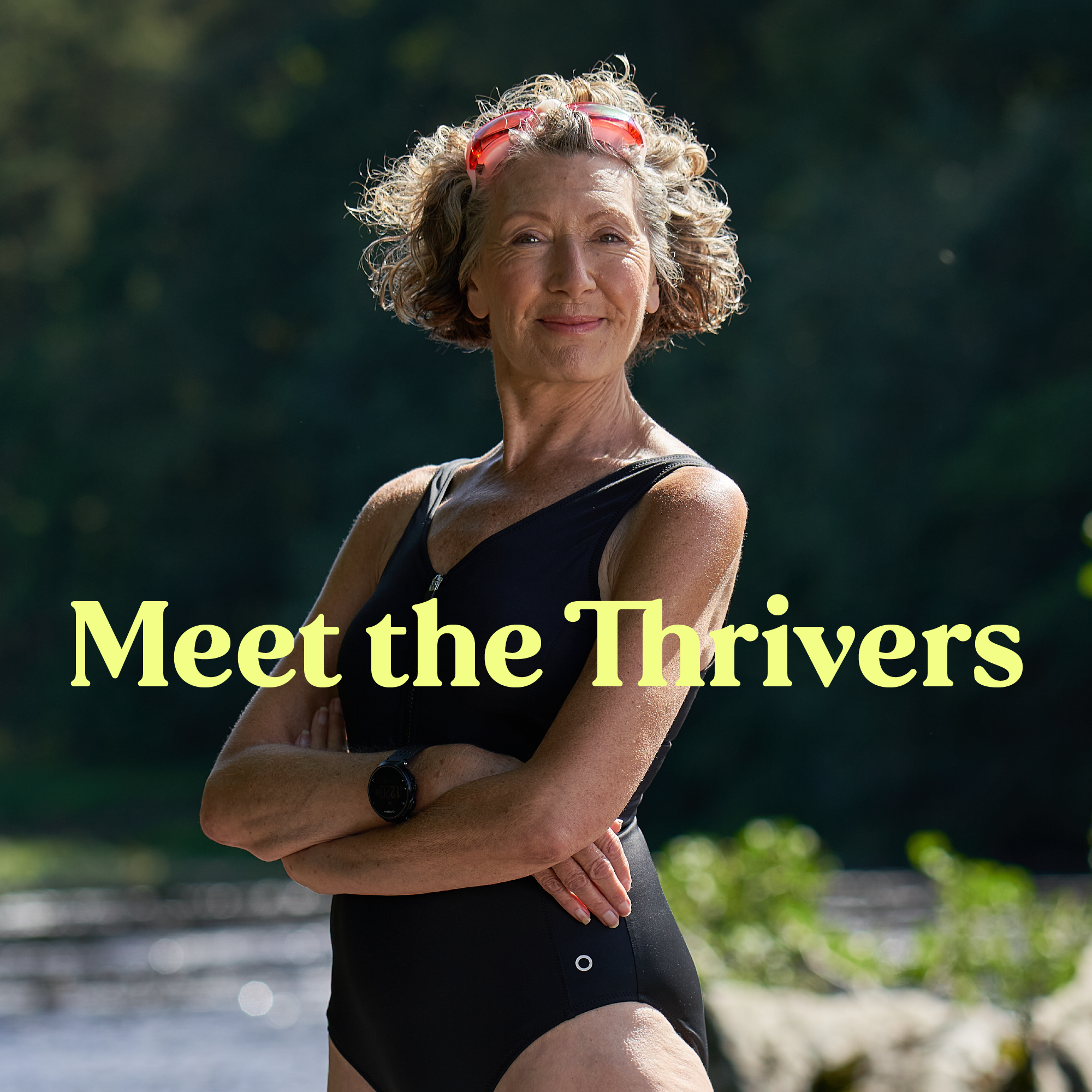 An elderly woman stands proudly river side in her swimming costume, with pink goggle strapped to her head. Light yellow text run across her saying "Meet the Thrivers"
