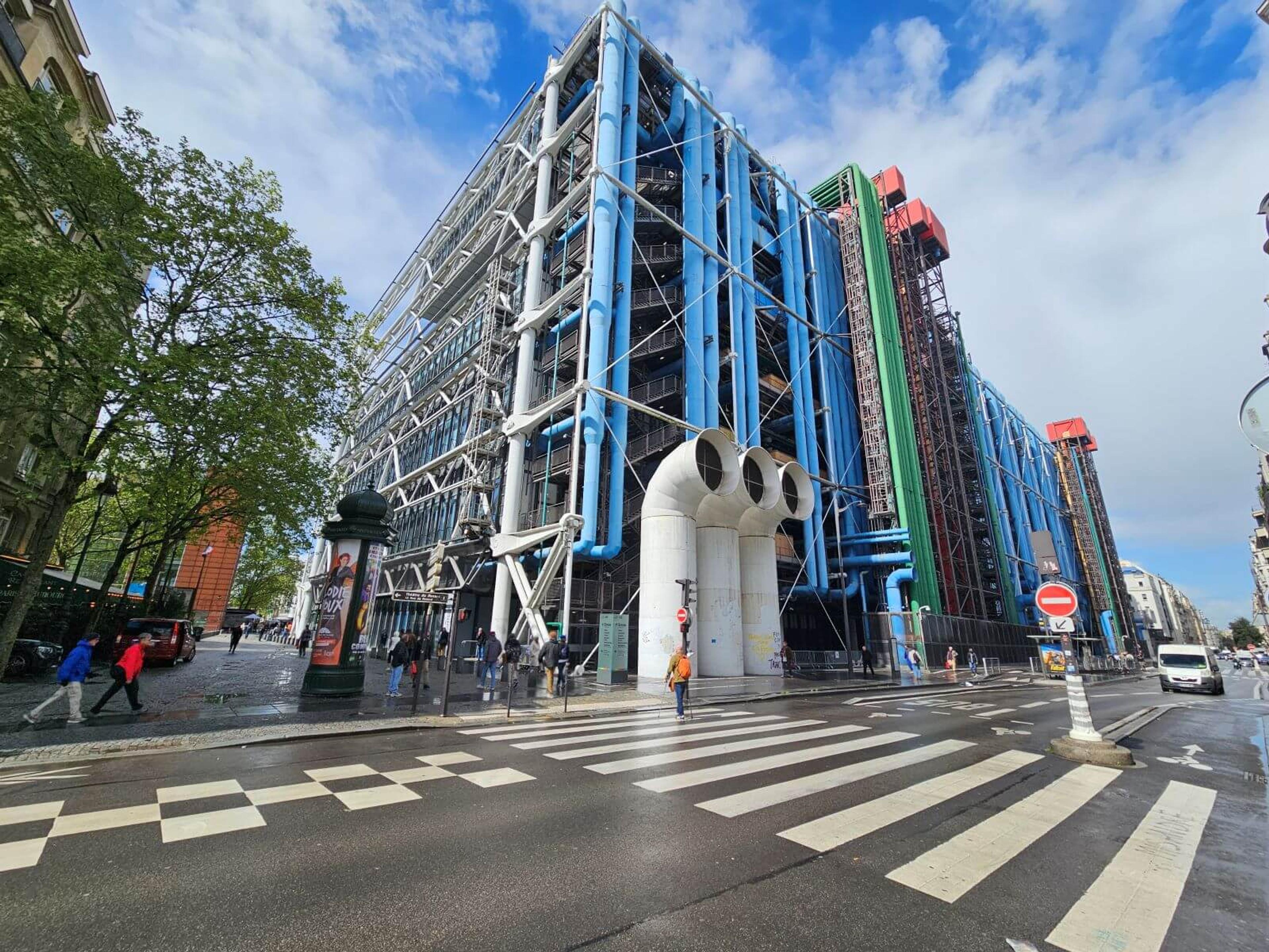 Image of Centre Pompidou taken from a crossing, allowing you to see the magnificent pipe construction