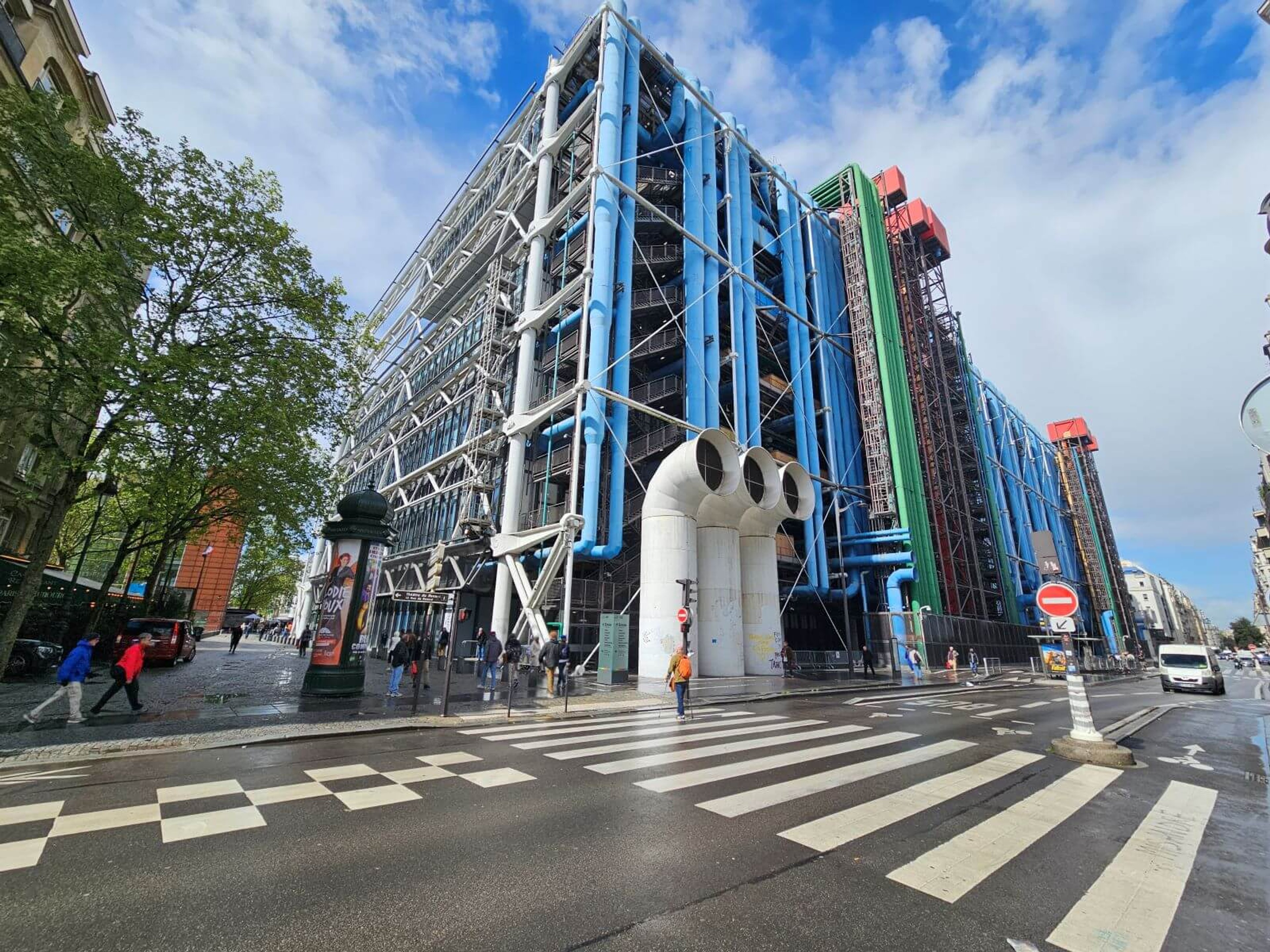 Image of Centre Pompidou taken from a crossing, allowing you to see the magnificent pipe construction