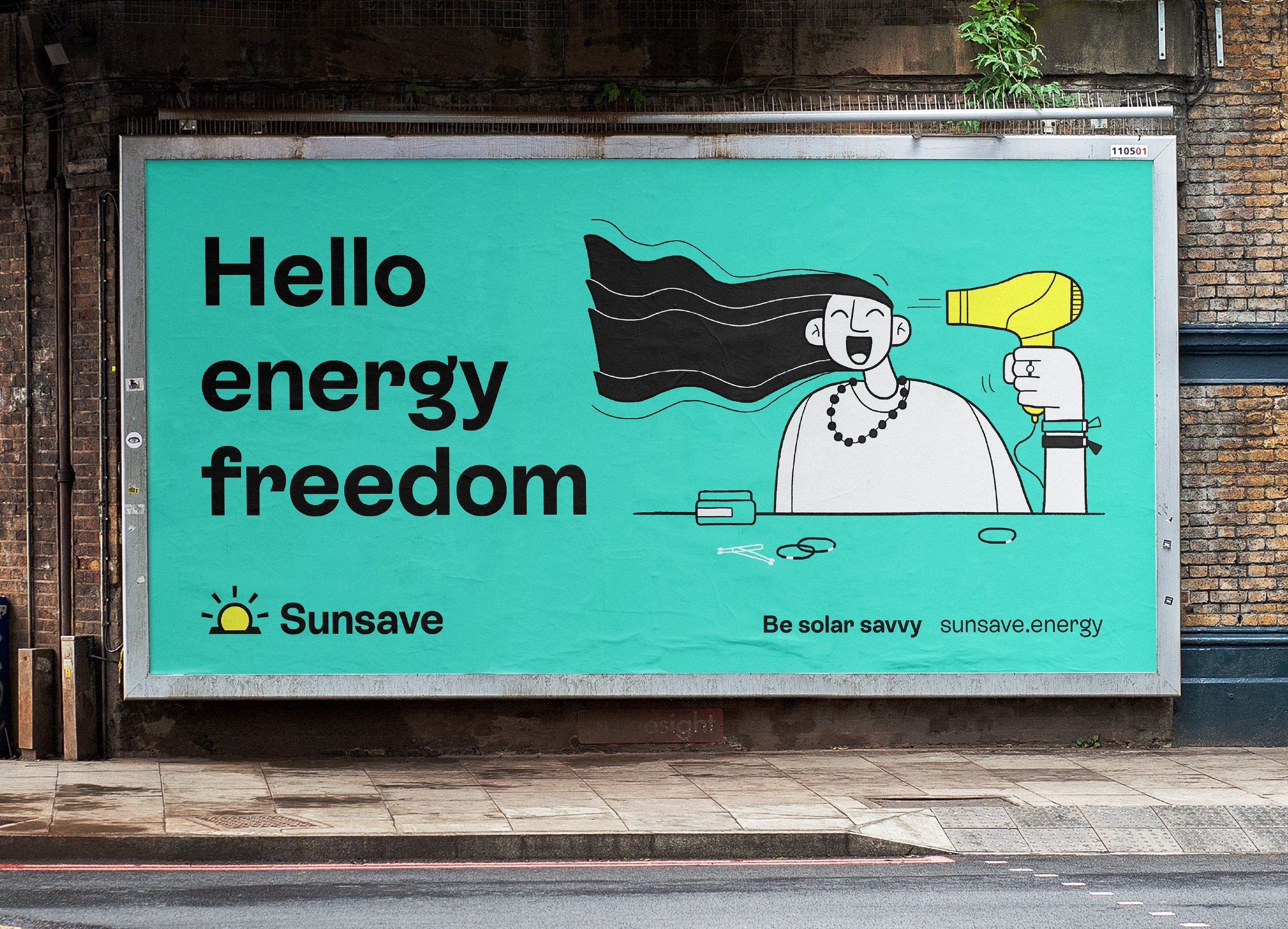 Billboard advert for the brand SunSave is displayed next to the side of a road. The copy on screen reads “Hello energy freedom” and features a filled line illustration of a character who is drying their hair with a yellow hairdryer. The text and illustration is set on a teal background within the billoard frame