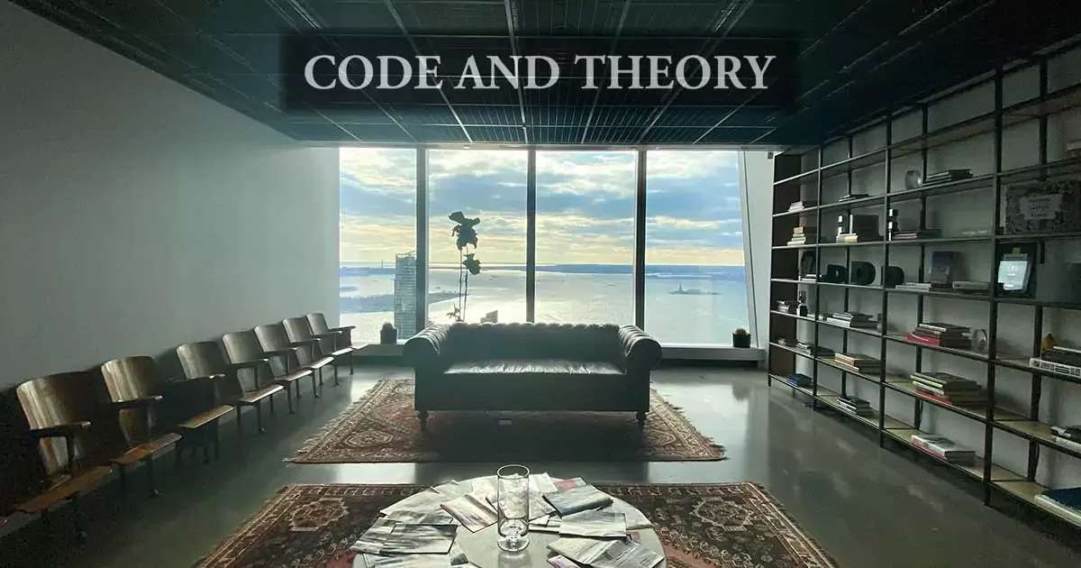 Office interior with a large window view, leather couch, and bookshelves.