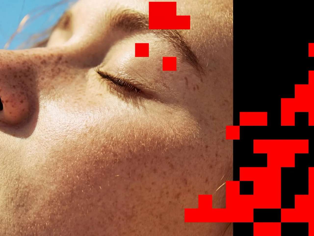 Close-up of a person's face with red pixelated overlay on the right side.