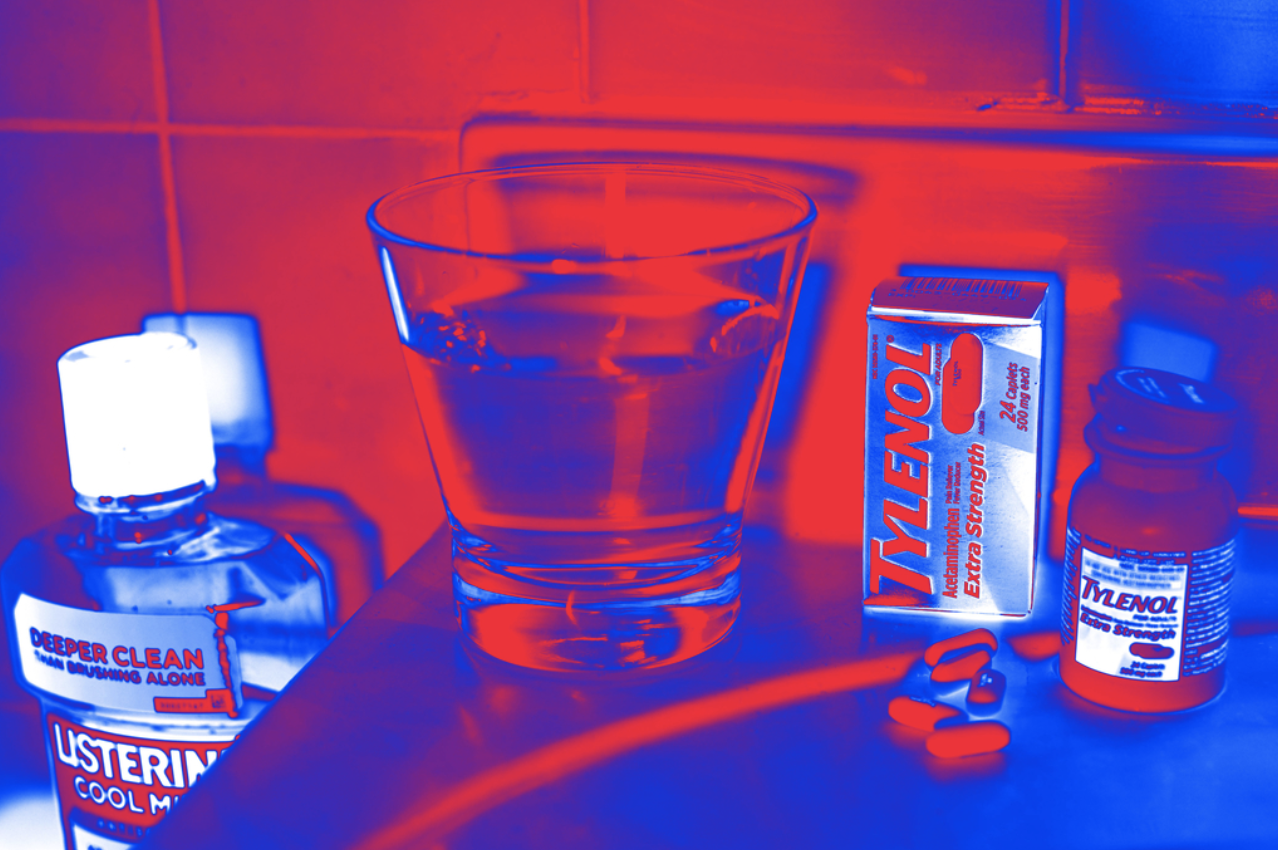 Photo of Tylenol and Listerine products with a glass of water.