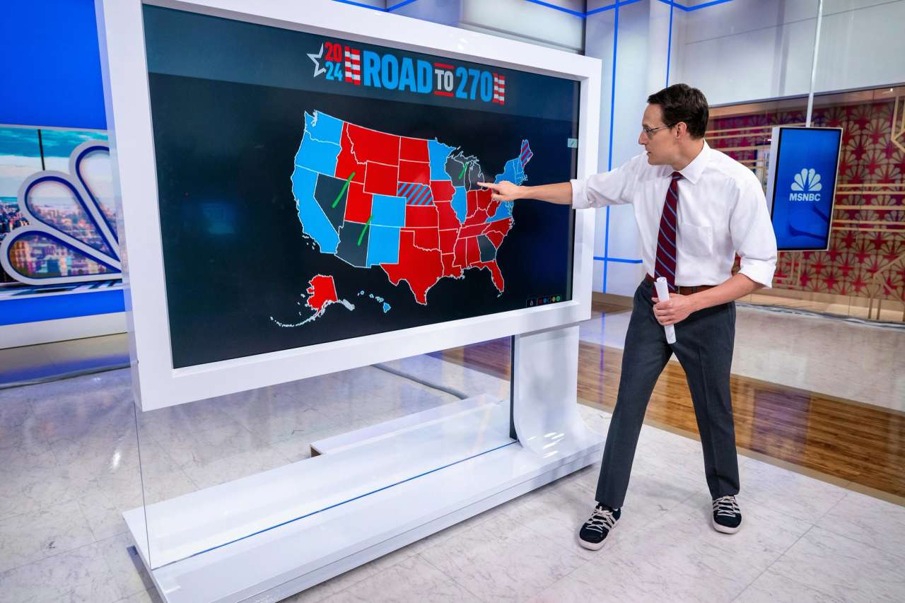 Interactive display showing a U.S. electoral map with red and blue states, labeled '2024 Road to 270', in a studio setting.