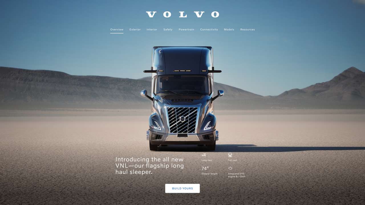 Front view of a Volvo VNL truck on a desert landscape.