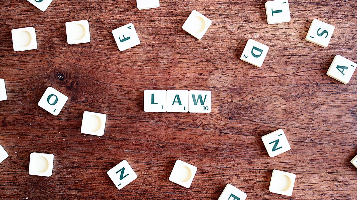 Scrabble letters spelling the word 'LAW'