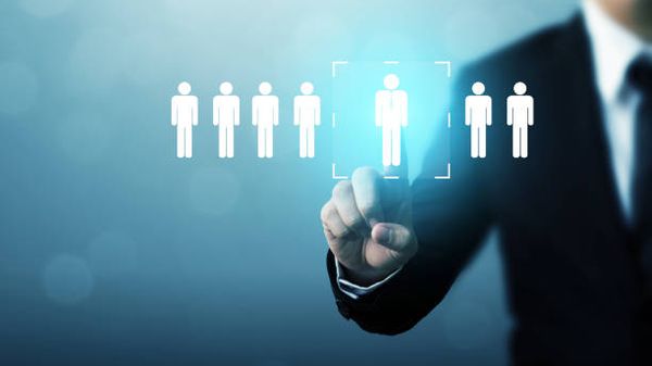 Male in a suit selecting a male icon from a group of male icons