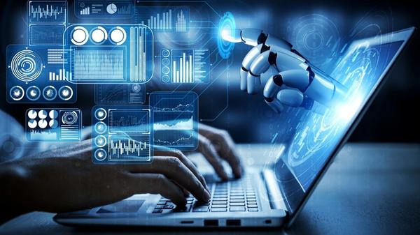 Laptop with human hands on keyboard and a robotic hand coming out of the screen with analytic icons surrounding the laptop