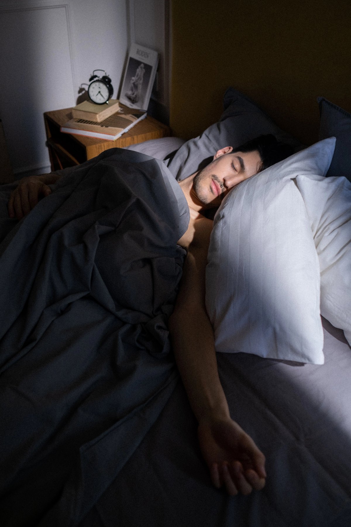 man sleeping in a dark room