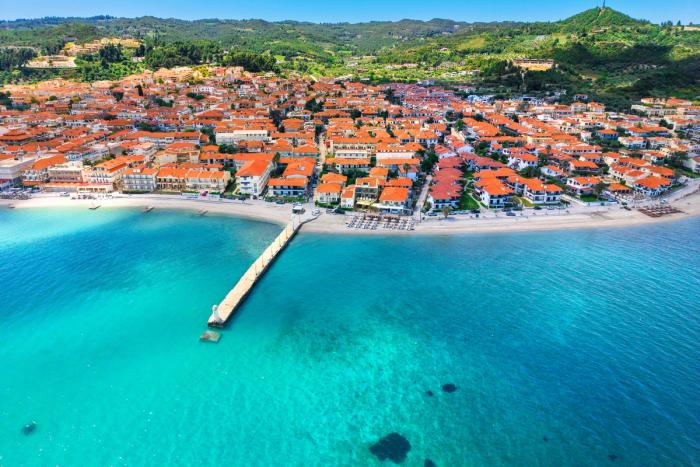 Beachfront village and calm Aegean waters