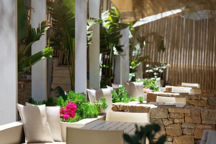 Terrace seating with tropical plants and stone walls