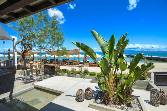Outdoor bar area with pergola and tropical plants