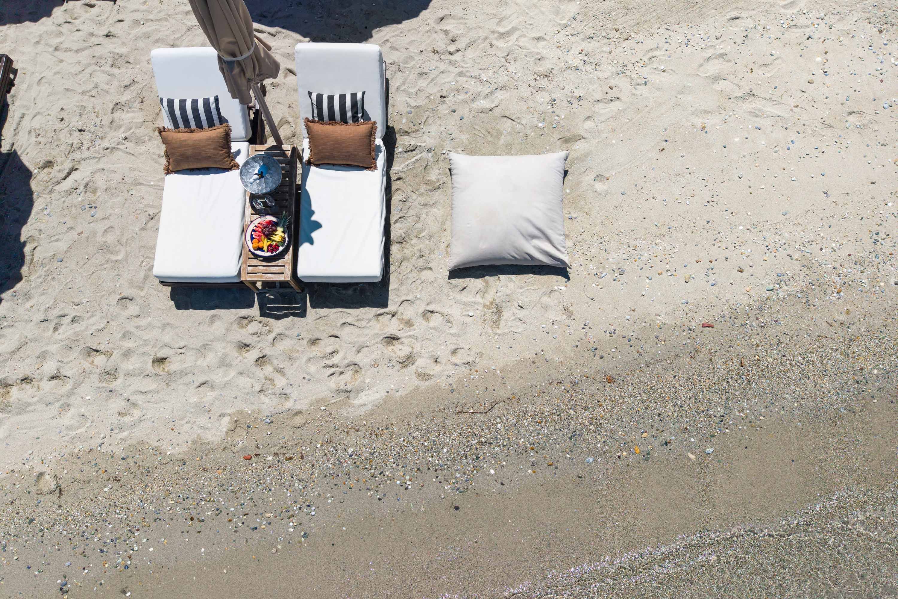 Relaxing on comfortable sunbeds by the sea