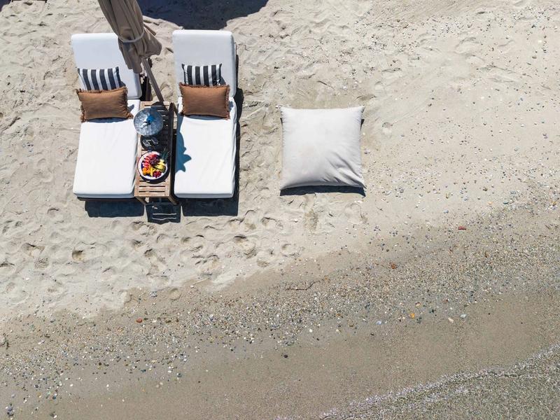Relaxing on comfortable sunbeds by the sea