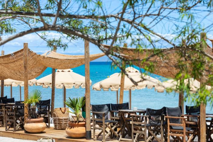Beach bar terrace with umbrellas and woven shades