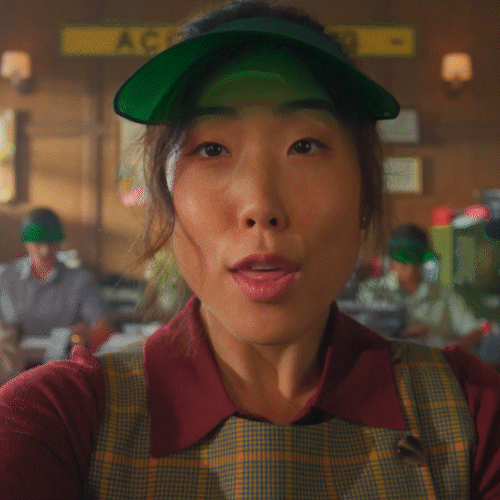 Hiscox creative campaign scene showing an accountant seated at a counter with coworkers.
