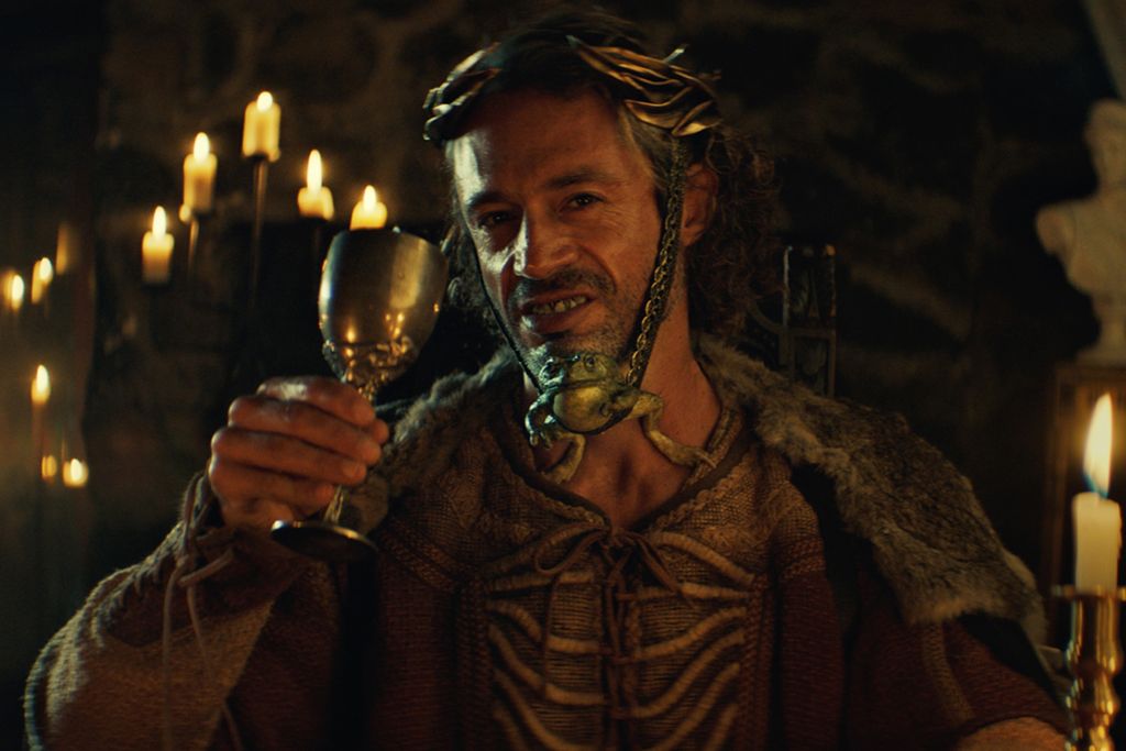 Medieval character raising a goblet in a candlelit scene for the Long Live Your Teeth campaign