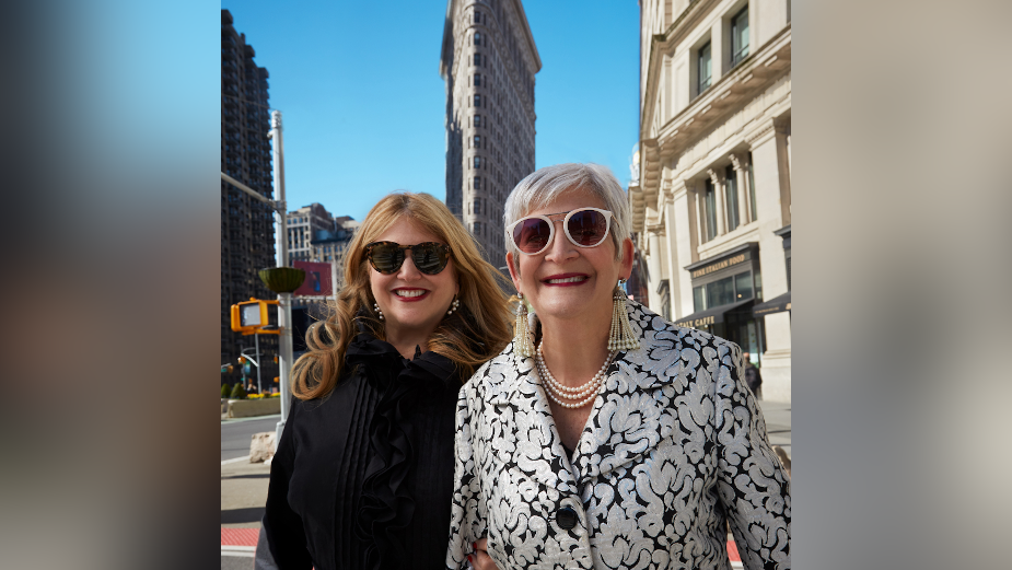 Terri and Sandy smiling together on a New York City street.