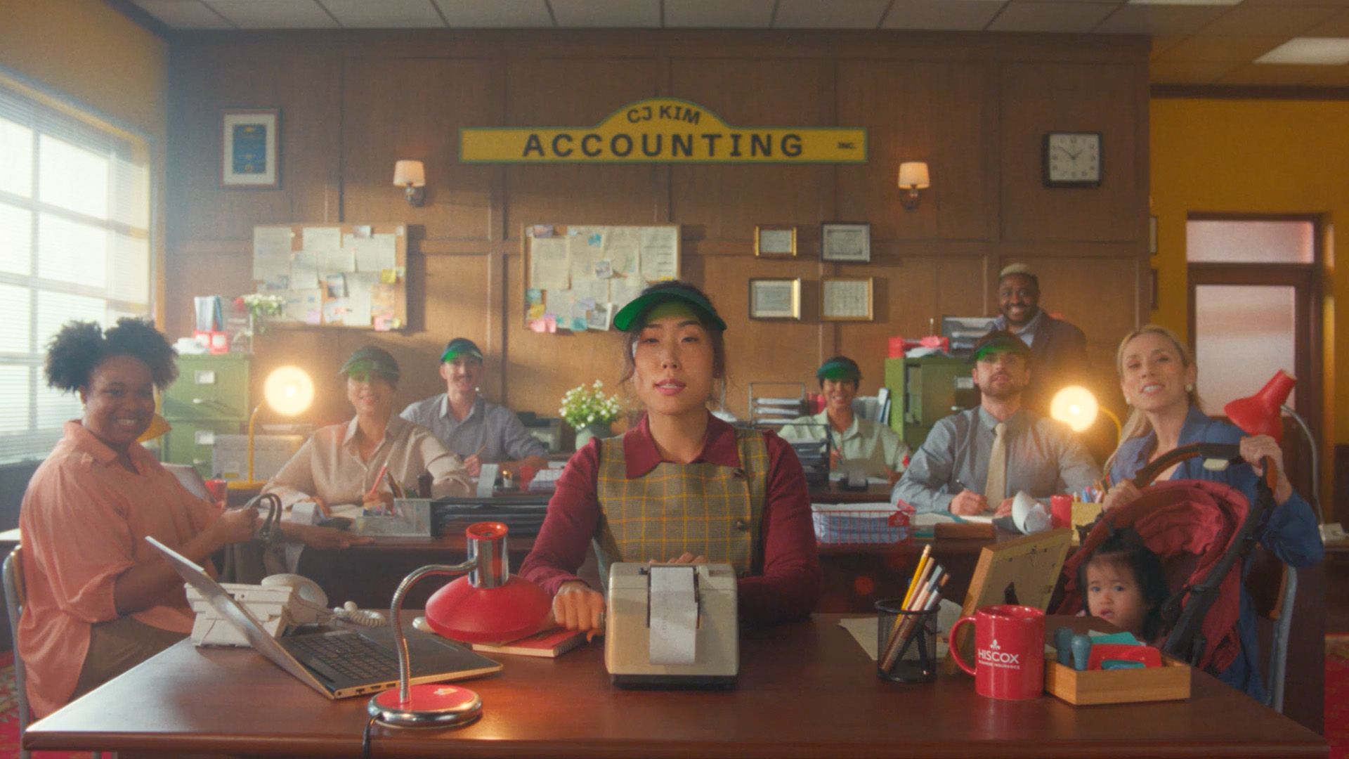 Hiscox accounting campaign featuring a team of employees working in a vintage-style accounting office.