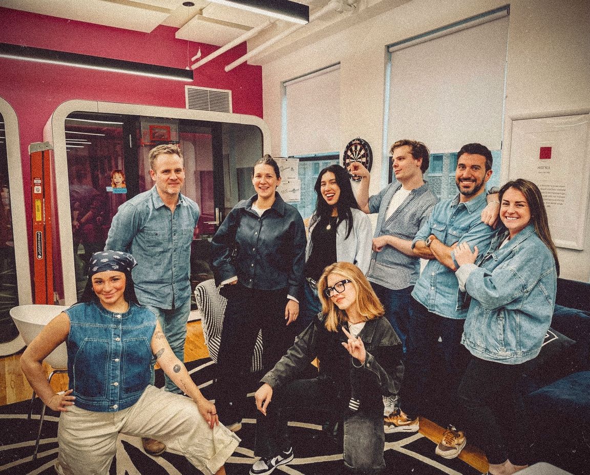 Terri & Sandy agency team members posing together in their New York office, all wearing different types of denim