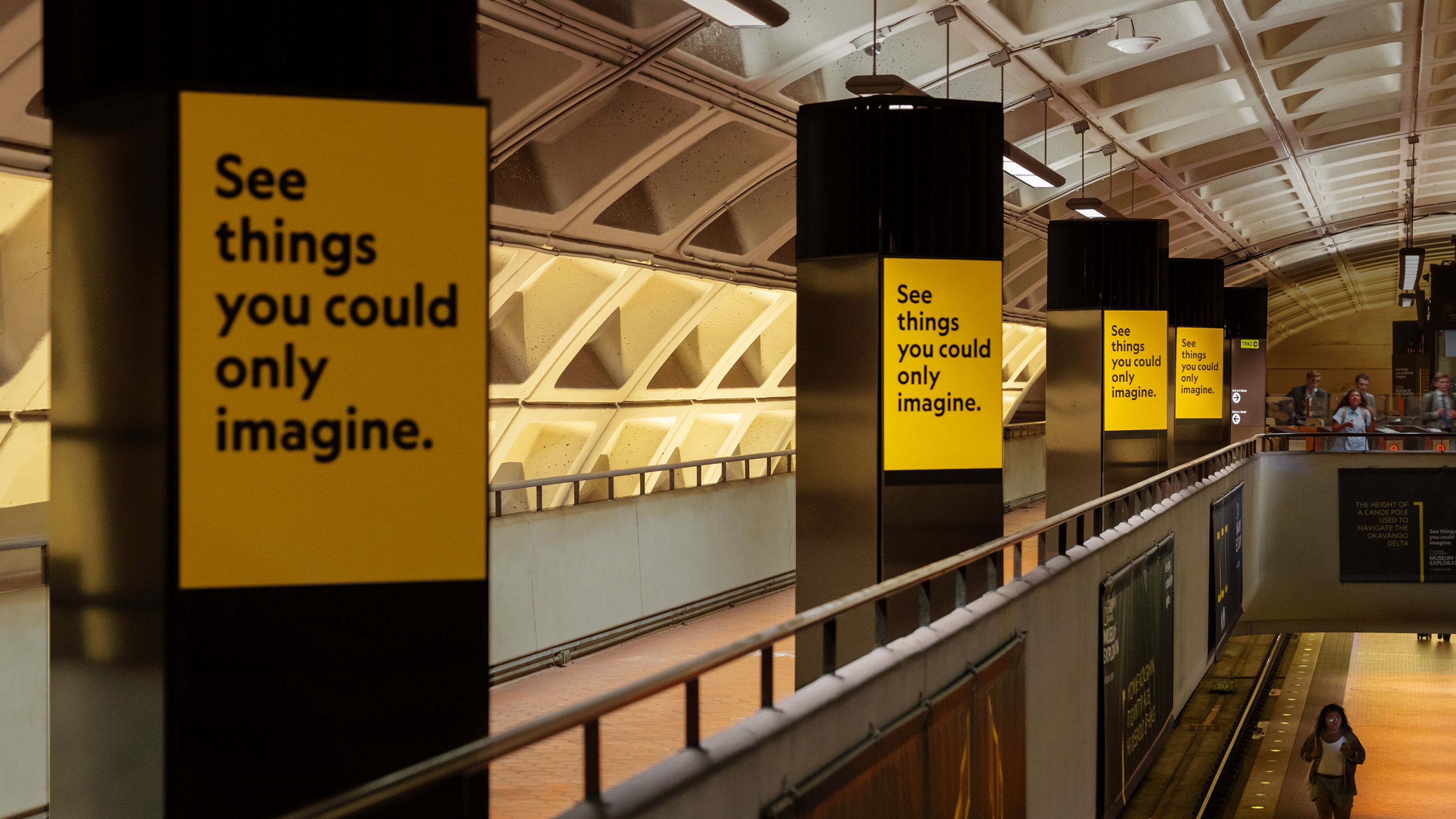 National Geographic Museum of Exploration ads reading “See things you could only imagine” displayed along a subway platform.