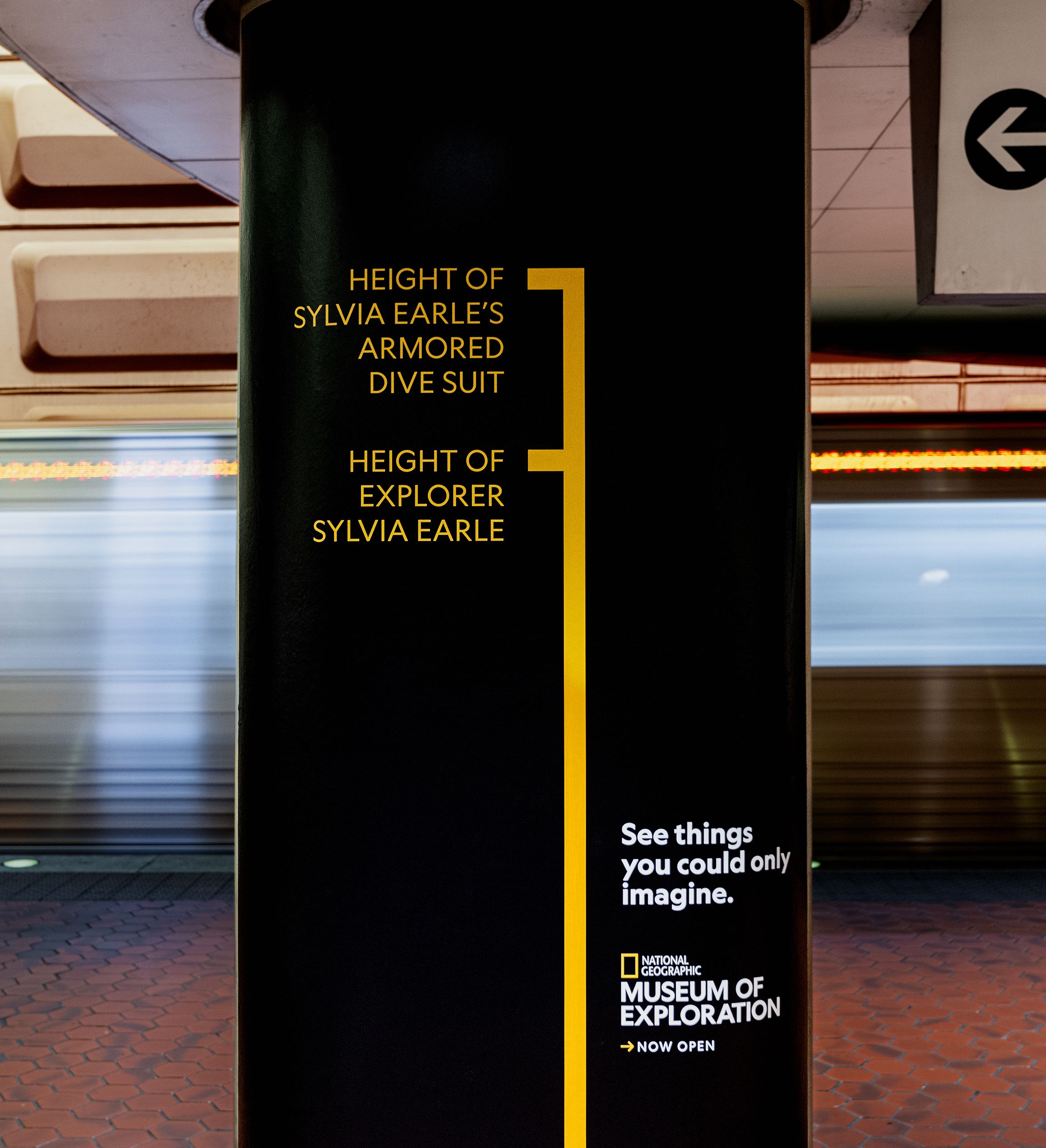National Geographic Museum of Exploration subway ad comparing the height of Sylvia Earle’s armored dive suit with the ocean explorer.