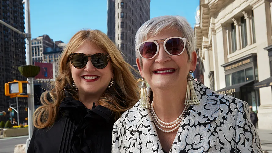 Terri and Sandy wearing sunglasses posing together on a New York City street.