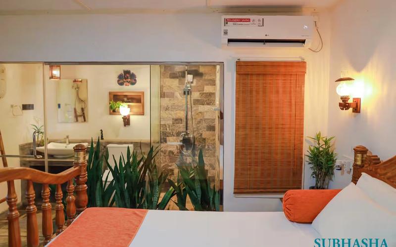 This spacious bedroom has an ensuite shower room and furniture.