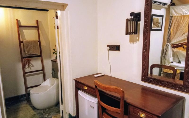 A thoughtfully designed room at Lotus Court, featuring elegant interiors, modern amenities, and a serene ensuite bathroom for a relaxing stay.