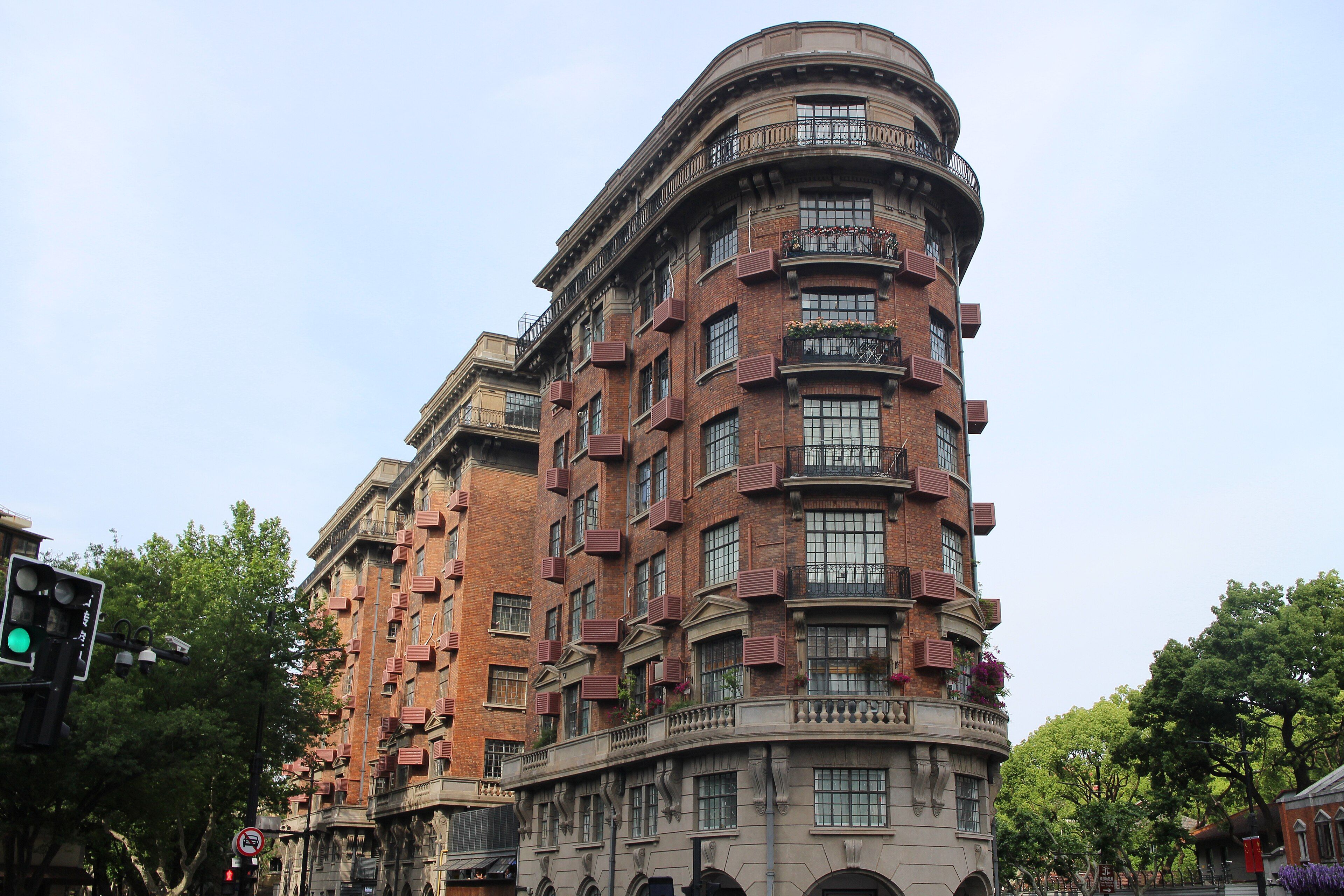 The wedge-shaped brick Wukang Mansion at the corner of Wukang Road and Huaihai Middle Road