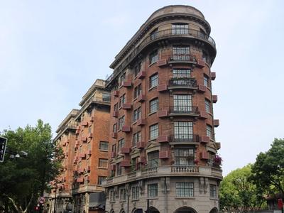 The wedge-shaped brick Wukang Mansion at the corner of Wukang Road and Huaihai Middle Road