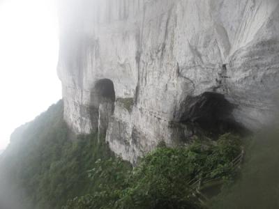Mist around the limestone cliffs and the cliff-edge walkway on Jinfo Mountain