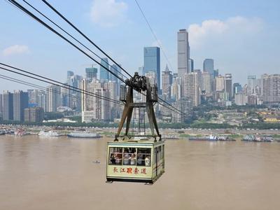 A Yangtze River Cableway cabin crossing the river, with the Yuzhong skyline behind it