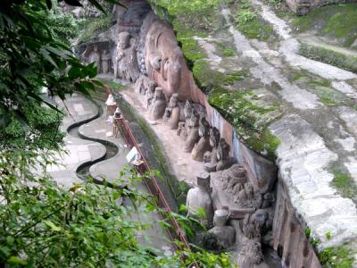 The reclining Buddha and its attendant figures carved into the cliff at Baodingshan, Dazu