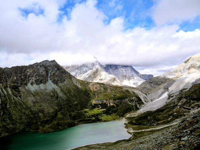 Alpine lake ringed by glaciated peaks in Yading Nature Reserve, Daocheng, western Sichuan