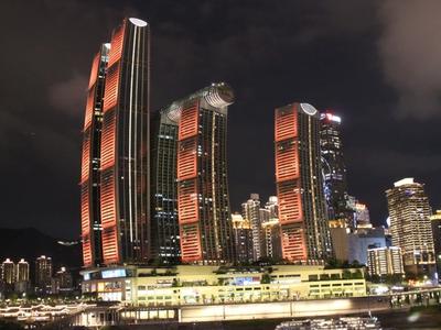 The Raffles City towers and their sky bridge lit up above Chaotianmen at night
