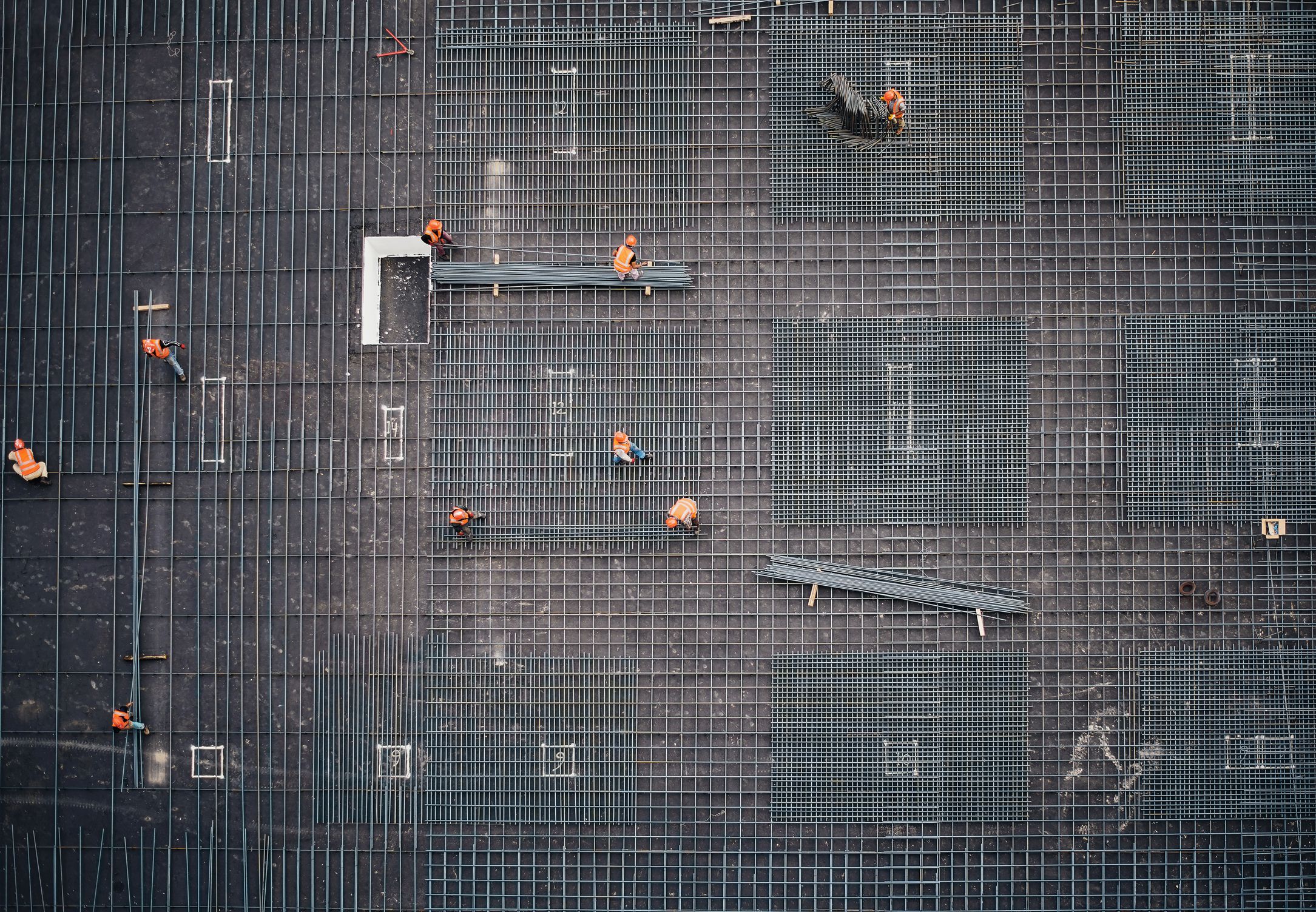 A construction site with prominent orange workers