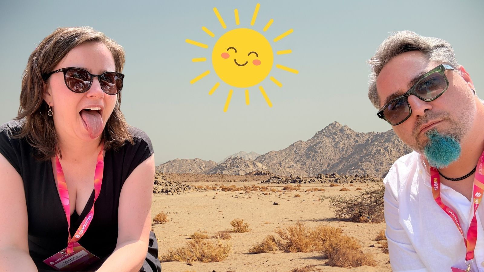 Lisa and Daniel are acting weird in front of a picture from a desert landscape and an illustration of the sun.