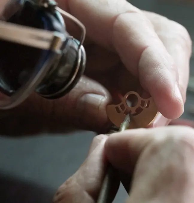 Dominique Renaud engraving a piece of the Perpetual Secular Calendar Movement