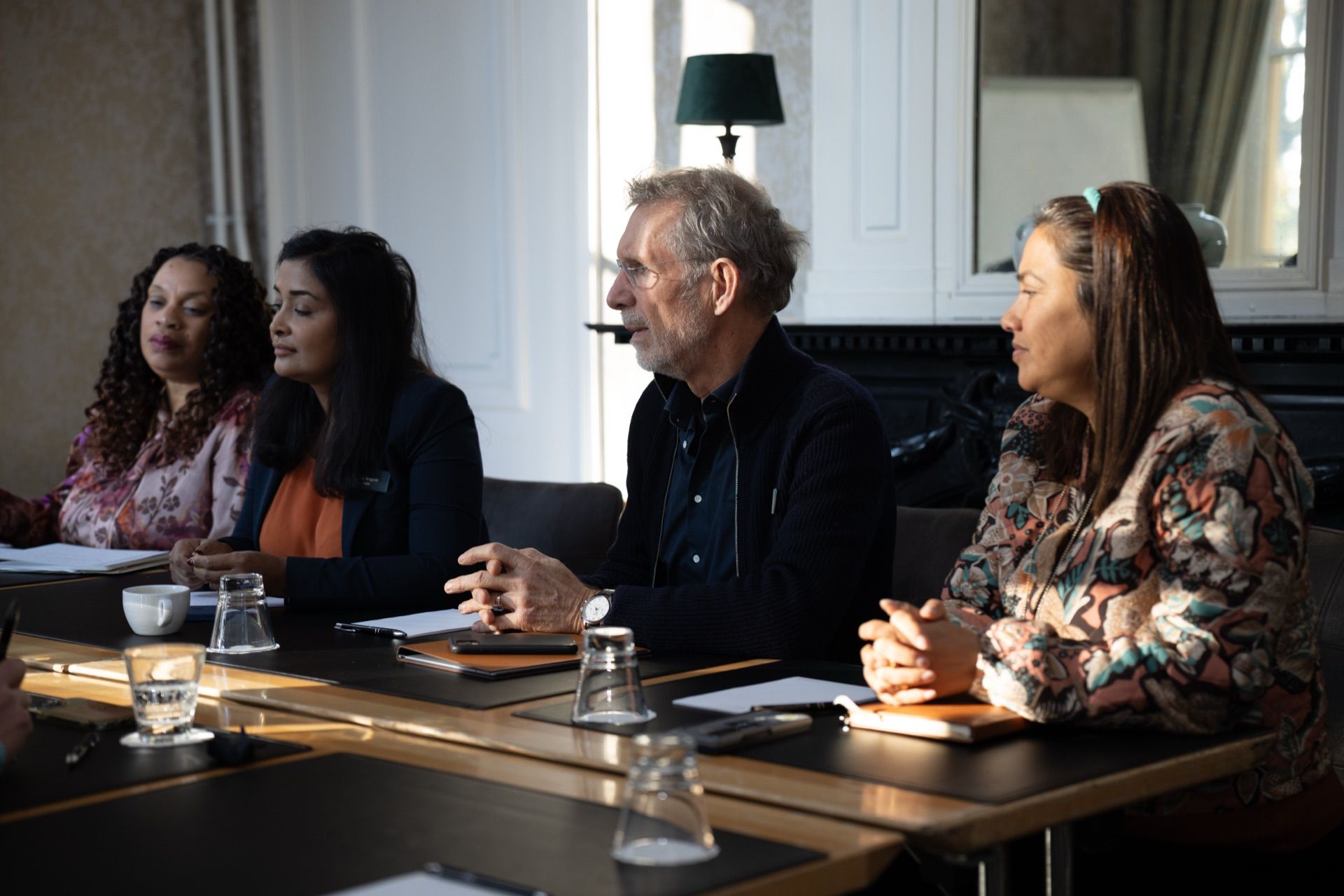 Participants in discussion around a boardroom table