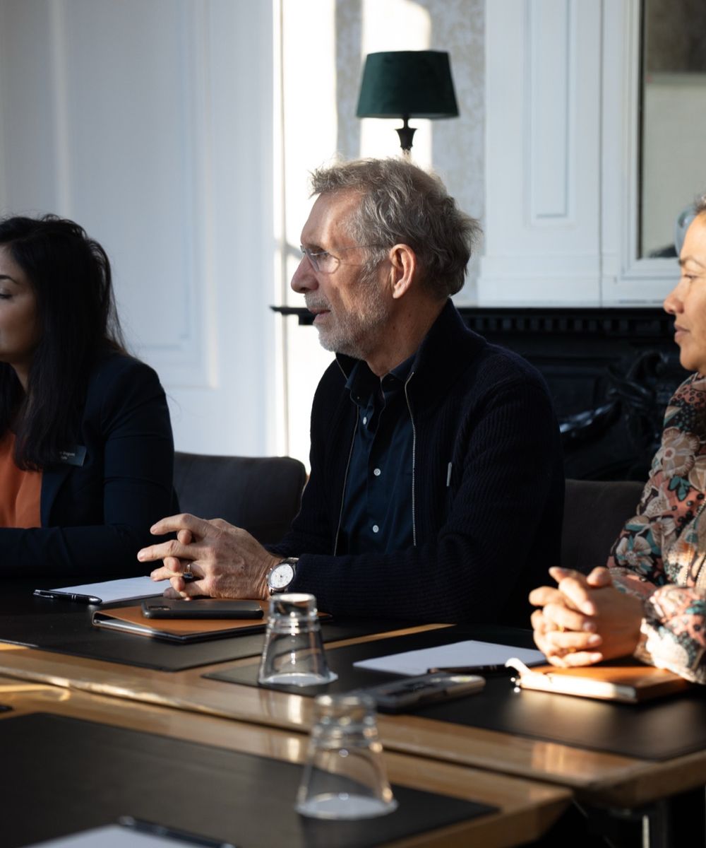 Participants in discussion around a boardroom table