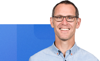 Headshot of rob chase from mediavalet with a geometric blue background